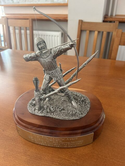 Archery trophy on wooden plinth